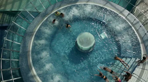 High angle crane of young people going into pool Stock Footage 31680907