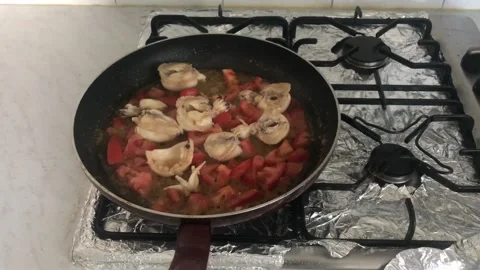 High Angle of Cuttlefishes With Chopped Tomatoes On The Pan Video stock 130916104