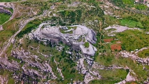 High Angle Descent Above Massive Rock Formations in a Rugged Landscape Stock Footage 341222287