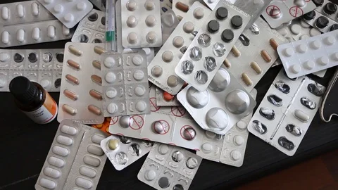 High angle, detail, medication lying on table, coronavirus pandemic, alcohol and Video stock 128525205