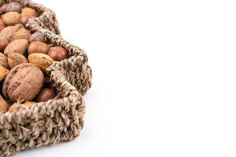 High angle detail studio shot of basket full of mixed nuts isolated on white Stock Photos