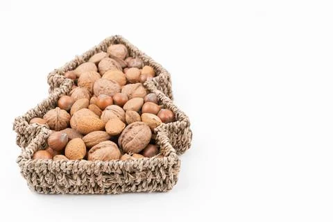 High angle detail studio shot of basket full of mixed nuts isolated on white Stock Photos