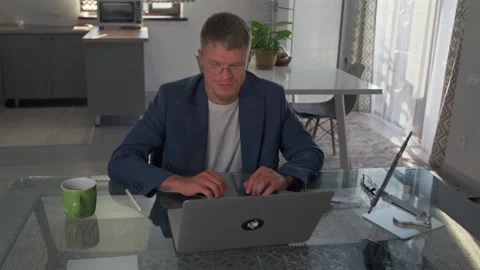 High angle. Developer discusses app improvements, adjusts code on laptop. Stock Footage 299903269