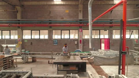 High Angle Dolly Shot of People Working in a Factory Stock Footage 166698461