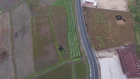 High Angle Drone Aerial View of Winding Rural Road Passing Through Farmlands Stock Footage 346008140