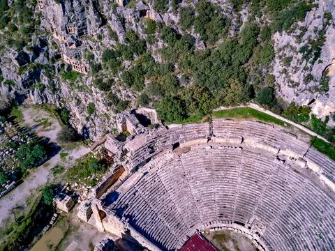 High angle drone aerial view of ancient greek rock cut lykian empire amphithe Stock Photos