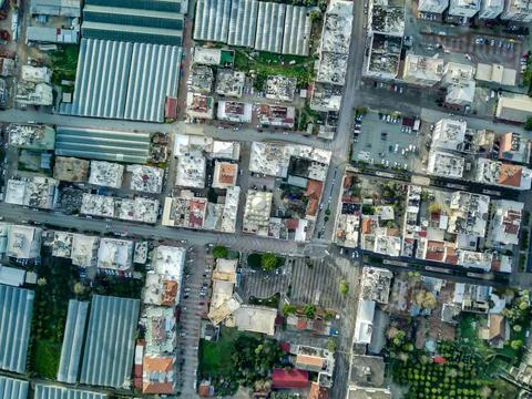 High angle drone aerial view of greenhouse fields of greens plantation in Dem Stock Photos