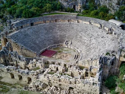 High angle drone aerial view of ancient greek rock cut lykian empire amphithe Stock Photos