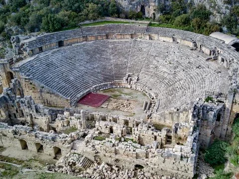 High angle drone aerial view of ancient greek rock cut lykian empire amphithe Stock Photos