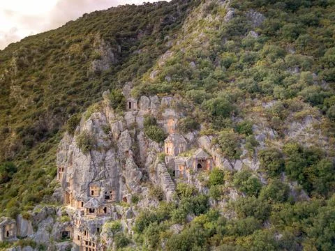 High angle drone aerial view of ancient greek rock cut tombs carved into clif Stock Photos