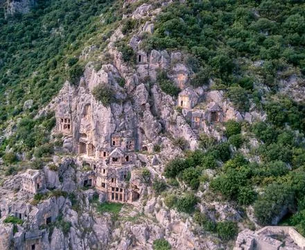 High angle drone aerial view of ancient greek rock cut tombs carved into clif Stock Photos