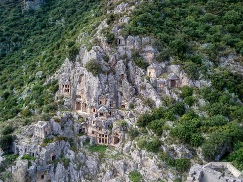 High angle drone aerial view of ancient greek rock cut tombs carved into clif Stock Photos