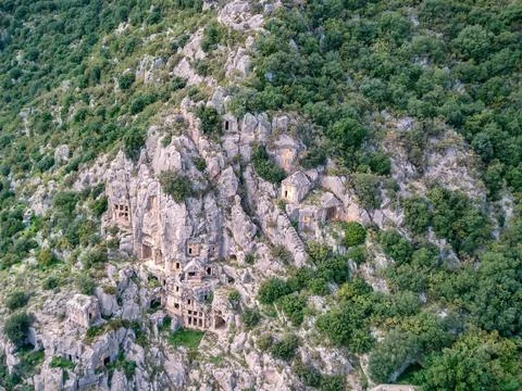 High angle drone aerial view of ancient greek rock cut tombs carved into clif Stock Photos