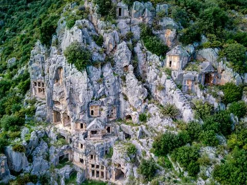 High angle drone aerial view of ancient greek rock cut tombs carved into clif Foto stock