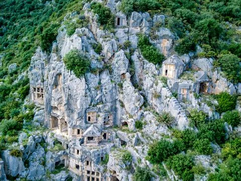 High angle drone aerial view of ancient greek rock cut tombs carved into clif Stock-Fotos