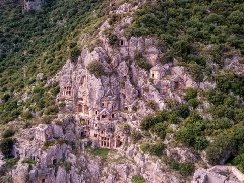 High angle drone aerial view of ancient greek rock cut tombs carved into clif Stock Photos