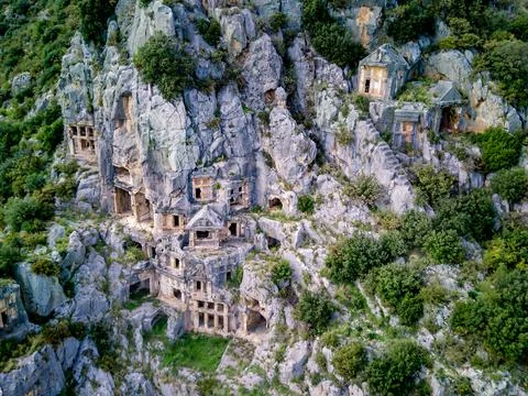 High angle drone aerial view of ancient greek rock cut tombs carved into clif Foto stock
