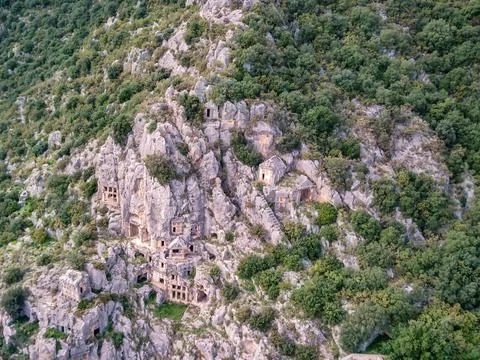 High angle drone aerial view of ancient greek rock cut tombs carved into clif Stock Photos