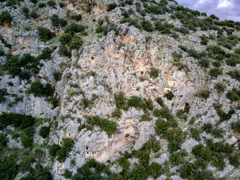 High angle drone aerial view of ancient greek rock cut tombs carved into clif Stock Photos