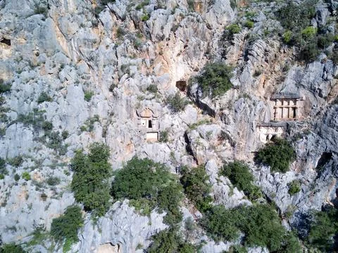 High angle drone aerial view of ancient greek rock cut tombs carved into clif Stock Photos