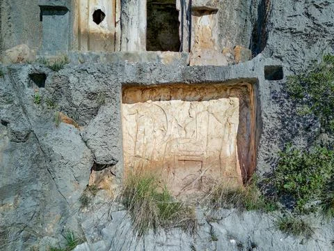 High angle drone aerial view of ancient greek rock cut tombs carved into clif Stock Photos