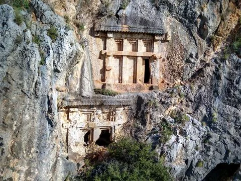 High angle drone aerial view of ancient greek rock cut tombs carved into clif Stock Photos