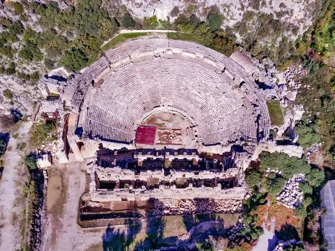 High angle drone aerial view of ancient greek rock cut lykian empire amphithe Stock Photos