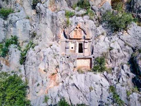 High angle drone aerial view of ancient greek rock cut tombs carved into clif Stock Photos