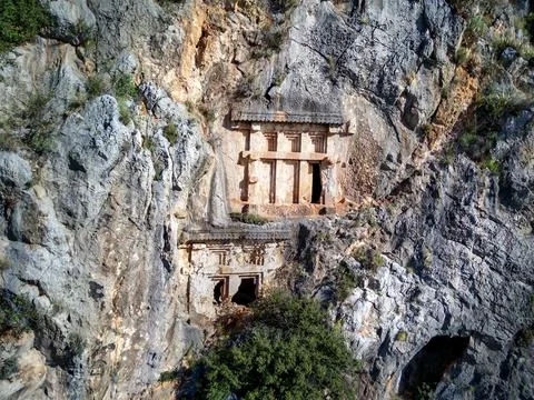 High angle drone aerial view of ancient greek rock cut tombs carved into clif Stock Photos