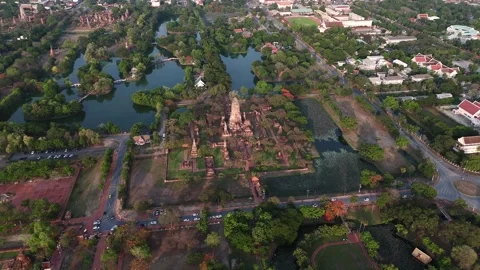 High-angle drone capture of Wat Phra Ram with its main prang, brick ruins, and Stock Footage 312538405