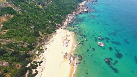High angle drone flight along a golden beach with clear sea bed 4K Stock Footage 340069132