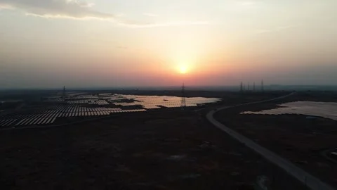 High-angle-drone-flight-solar-farm-transmission-towers-sunset Stock Footage 342804285