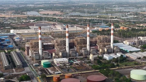 High angle drone footage capturing a large thermal power plant with towering 動画素材 332814990