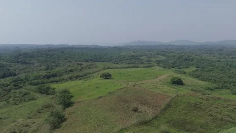 High angle drone footage capturing the vast green hills and dense forest of a Video stock 337912615