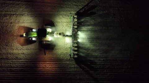 High-Angle Drone Footage at Nighttime Tractor Planting, modern agriculture. Stock Footage 279676964