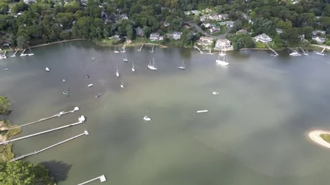 High angle drone footage slowly revealing a beautiful coastal harbor with many 스톡 동영상 331154130