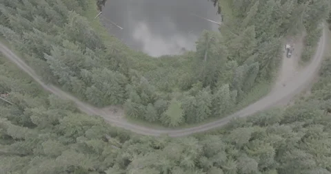 High-angle Drone Footage Small Reflective Lake Cloudy Day Washington State. Stock Footage 262600723