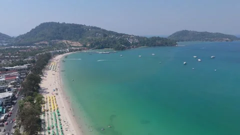 High angle drone overview of Patong city meeting the ocean Vídeos de archivo 333414121