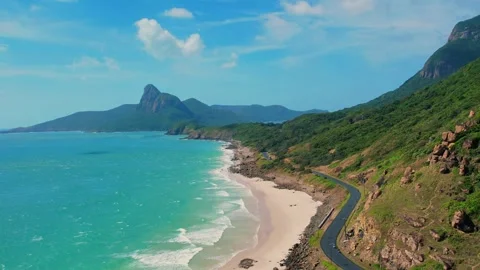 High angle drone pan over empty ocean road and paradise white beach 4K Vídeos de archivo 337152523
