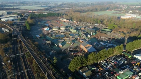 High-angle drone perspective of expansive manufacturing warehouses adjacent to Stock Footage 333937799