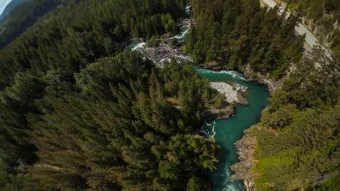 High angle drone perspective of a winding river channel and a massive log jam Foto stock
