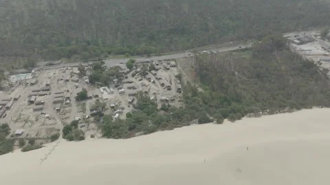 High angle drone pulling back revealing dune with camping foreground, France Stock Footage 333107883