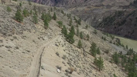 High Angle Drone Shot of 4X4 Pulling Trailer Down Mountain Road Stock Footage 146554017
