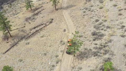 High Angle Drone Shot of 4X4 Pulling Trailer Down Mountain Road Stock Footage 146554174