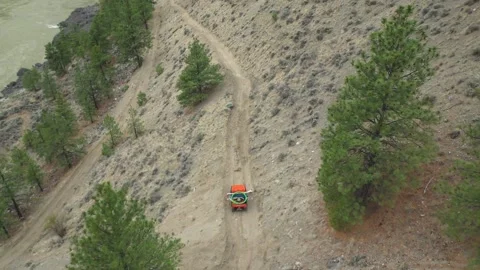 High Angle Drone Shot of 4X4 Driving Down a Mountain Road Stock Footage 146554399