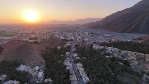 A high-angle drone shot of Birkat Al-Mawz in Oman's Interior region at sunse Stock Footage 337874212