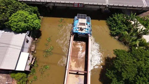 High angle drone shot of cargo boat reversing toward river bridge Stock-Footage 342390510