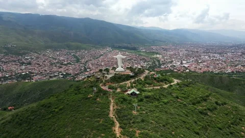 High angle drone shot circling the colossal Cristo de la Concordia religious Stock Footage 341316354