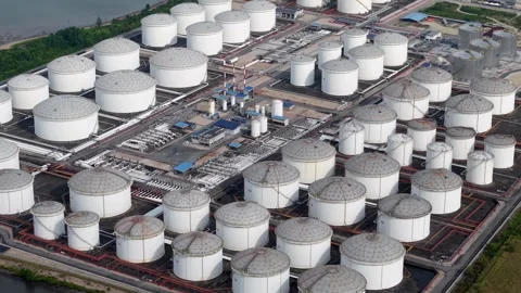 High angle drone shot of coastal oil storage tanks and industrial pipeline Stock Footage 332382878