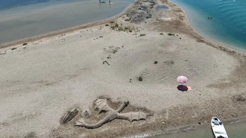 High Angle Drone Shot of Dragon Sand Sculpture on Beach Stock Footage 331807219